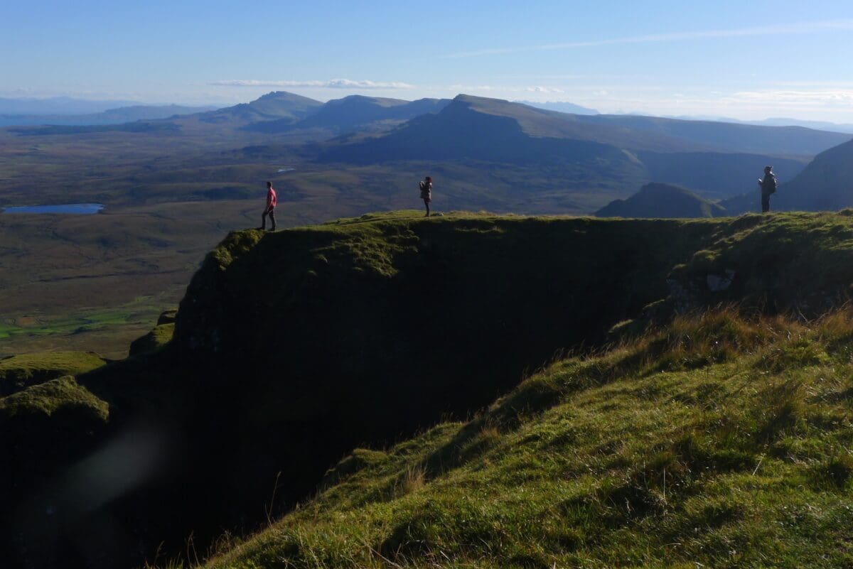 man standing on a mountain with arms open wide, scottish loch, loch ness, guided backpacking tour in the Scottish Highlands, hiking in the scottish highlands